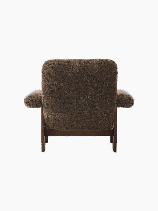 Back view of the Brasilia Lounge Chair, High Back, upholstered in brown Sheepskin Root with a visible dark stained oak frame.
