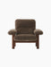 The Brasilia Lounge Chair shown from the front, featuring a dark stained oak frame and plush Root sheepskin upholstery.