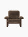 The low-slung Brasilia Lounge Chair seen from the front, with a dark walnut frame and plush, dark brown sheepskin upholstery.