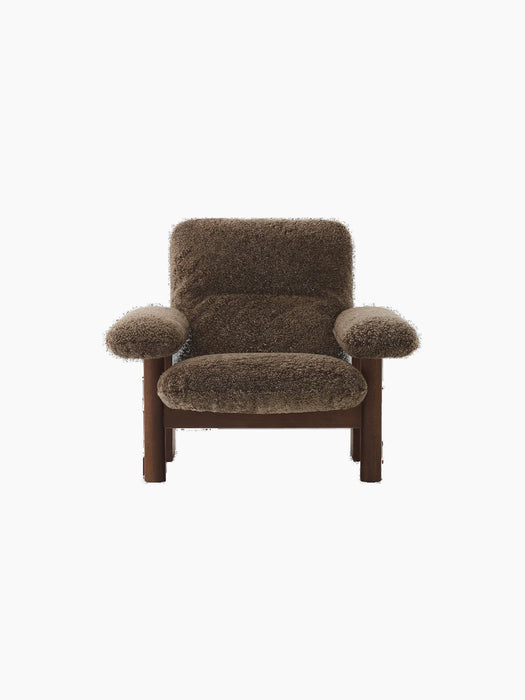 Front view of the Brasilia Lounge Chair with a high back, walnut frame and plush, dark brown Sheepskin Root upholstery.