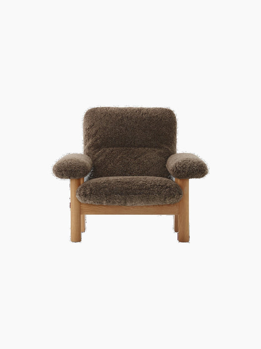 Front view of the high-back Brasilia Lounge Chair with a natural oak frame and upholstered in dark brown Root sheepskin.