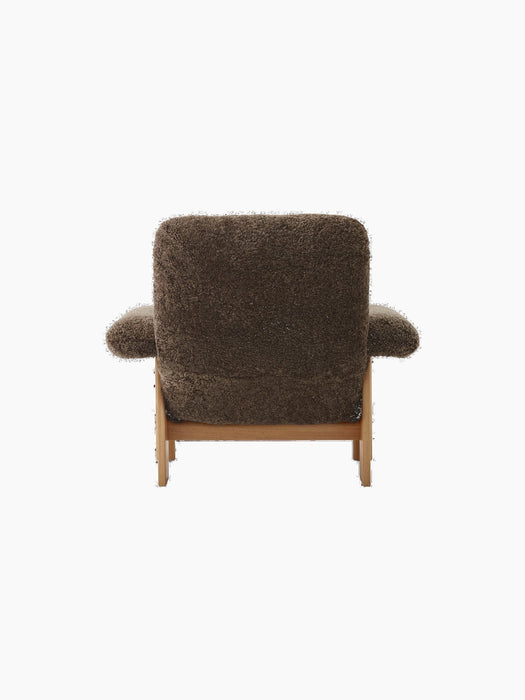 Back view of the Brasilia Lounge Chair, High Back, upholstered in dark brown Sheepskin Root with a natural oak frame.