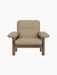 Front view of the Brasilia Lounge Chair with a walnut frame and beige Audo Bouclé 02 upholstery on a black background.
