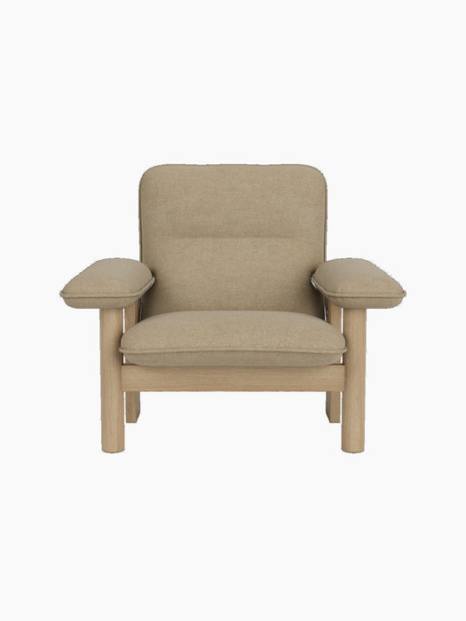 Front view of the Brasilia Lounge Chair with a natural oak frame and thick cushions upholstered in Audo Bouclé 02.