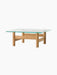 Front view of the Brasilia Lounge Table in natural oak. It has a square glass top on a sturdy base with four round legs.