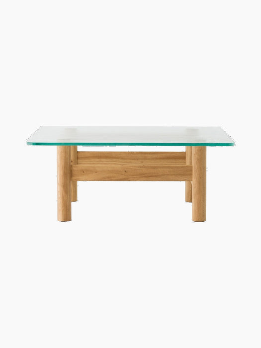 Front view of the Brasilia Lounge Table in natural oak. A rectangular glass top sits on a stout wooden base with chunky legs.