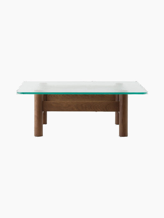 Front view of the Brasilia Lounge Table, featuring a square glass top on a sturdy natural oak base with four rounded legs.
