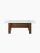 Front view of the Brasilia Lounge Table, featuring a square glass top on a sturdy natural oak base with four rounded legs.