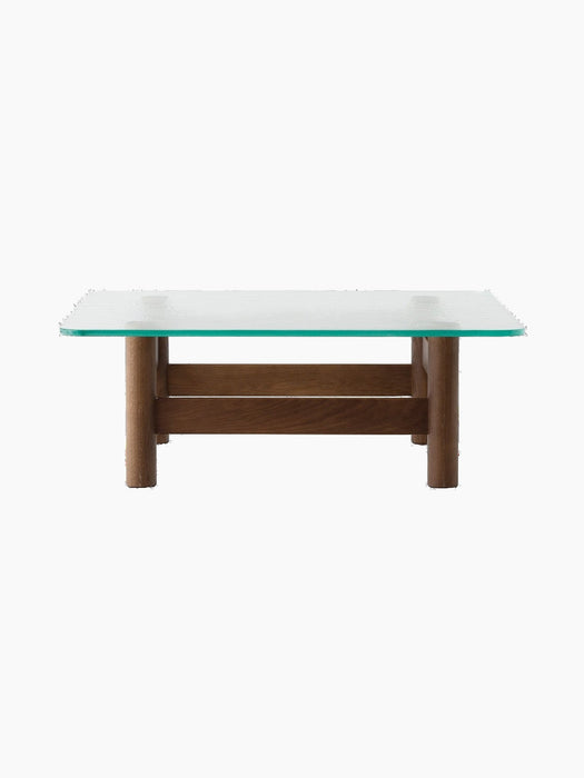 Side view of the Brasilia Lounge Table, featuring a rectangular glass top with rounded corners and a stout, dark wood base.