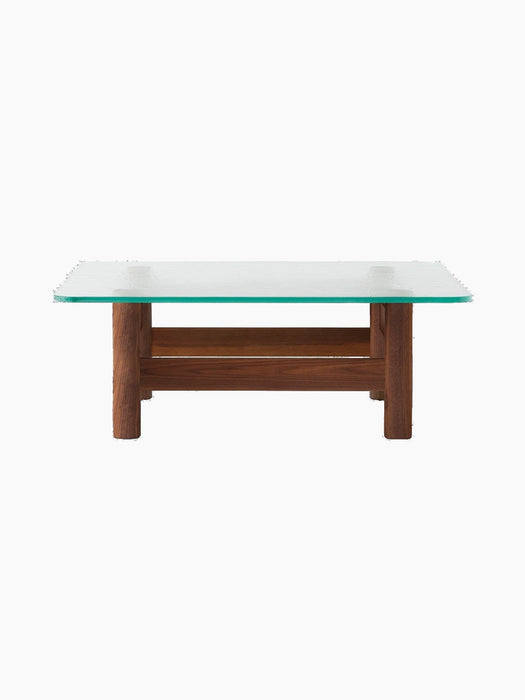 A back view of the Brasilia Lounge Table, showing its rectangular glass top and sturdy, rounded walnut wood base.
