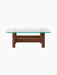 A back view of the Brasilia Lounge Table, showing its rectangular glass top and sturdy, rounded walnut wood base.