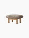 The Brasilia Ottoman, featuring a plush Sheepskin Nature cushion on a solid natural oak frame with four robust legs.