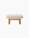 Front view of the Brasilia Lounge Ottoman, featuring a fluffy, off-white Sheepskin Nature cushion on a natural oak frame.