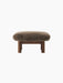 Front view of the Brasilia Ottoman in Sheepskin, with a dark stained oak frame and thick cylindrical legs.