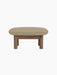 Side view of the Brasilia Ottoman with a walnut frame, thick cylindrical legs and a light beige Audo Bouclé 02 cushion.