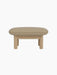 Side view of the Brasilia Ottoman with a light beige Audo Bouclé 02 cushion on a natural oak frame with thick, round legs.