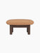 A side view of the Brasilia Ottoman, with a dark stained oak frame, four cylindrical legs, and plush camel leather seat.