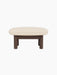 Side view of the Brasilia Ottoman with a dark stained oak frame and a light, textured Logan Jasmine fabric cushion.