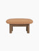 Brasilia Ottoman with a solid walnut frame, four thick cylindrical legs, and a soft, rounded camel leather cushion.