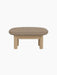 A side view of the Brasilia Ottoman, featuring a textured Logan Flint upholstered cushion and a solid natural oak wood frame.