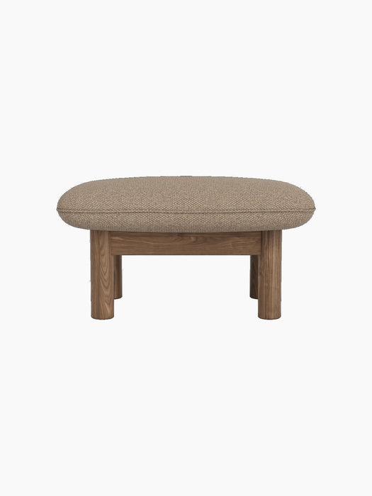 Side profile of the Brasilia Ottoman with a walnut frame and cushioned seat upholstered in textured Logan Flint fabric.