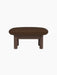 Side view of the Brasilia Ottoman, upholstered in brown Audo Bouclé 07 fabric, with four sturdy dark stained oak legs.