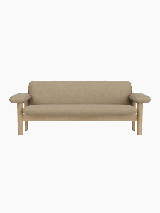 A front-on view of the two-seater Brasilia Sofa, featuring a natural oak frame and upholstered in light beige Audo Bouclé 02.