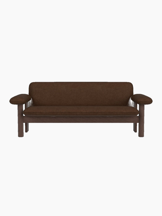 A front-on view of the Brasilia Sofa, featuring a dark stained oak frame and upholstered in a textured, brown bouclé fabric.