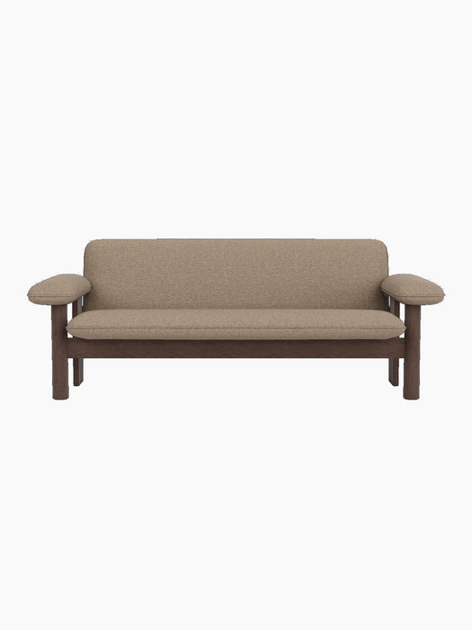 Front view of the Brasilia Sofa with a Dark Stained Oak frame and light brown Logan Flint upholstery on a black background.