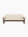 Front view of the Brasilia Sofa, featuring a dark stained oak frame and upholstered in light-coloured Logan Jasmine textile.