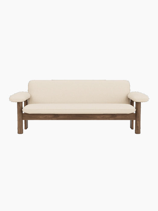 Front view of the Brasilia Sofa with a dark walnut frame and light-coloured Logan Jasmine textile upholstery.