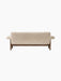 Back view of the Brasilia Sofa, upholstered in light sheepskin, showing the dark solid wood frame and rounded armrests.
