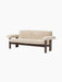 Front angle view of the Brasilia Sofa upholstered in plush, light beige Sheepskin with a sturdy, dark-stained wooden frame.