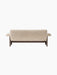 A back view of the Brasilia Sofa, upholstered in cream sheepskin, revealing its plush, textured back and dark wooden frame.