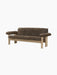Angled view of the Brasilia Sofa with a natural oak frame and upholstered in dark brown Sheepskin, on a black background.