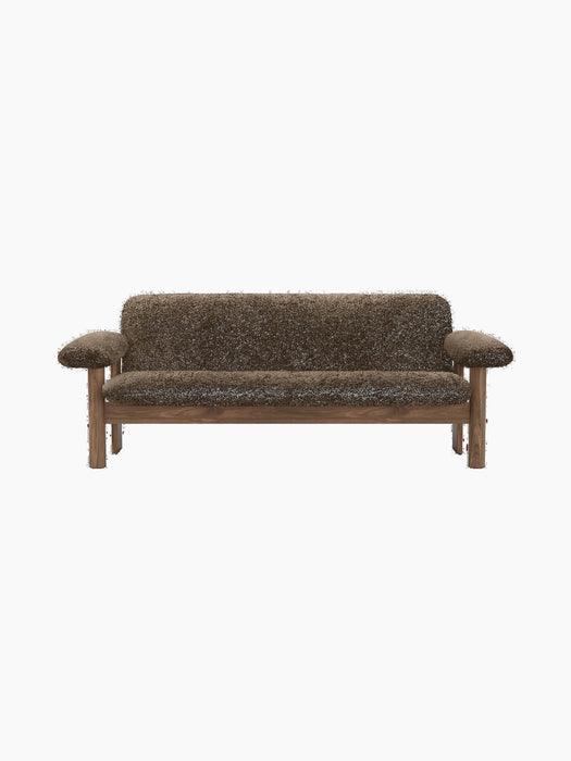A front view of the Brasilia Sofa in dark brown sheepskin. The sofa features a wooden frame with rounded legs and arms.