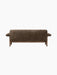 A rear view of the Brasilia Sofa, showcasing its textured brown sheepskin upholstery, wooden base, and prominent armrests.