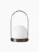 Front view of the Carrie Table Lamp in bronzed brass, featuring a white opal glass orb and a handle wrapped in brown leather.