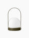 A back view of the Carrie Portable Table Lamp in olive, with its round olive base, white glass orb and thin handle.