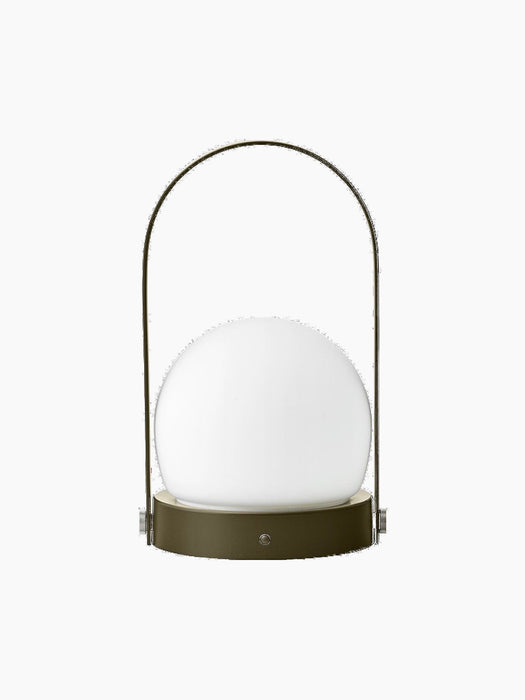 A front view of the Carrie Table Lamp, Portable. It has an olive base, a white frosted glass orb, and a thin, arched handle.