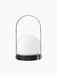 Back view of the black Carrie Portable Table Lamp features a matte black base, a white glass orb, and a thin metal handle.