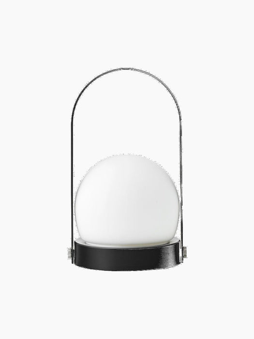 The black Carrie Portable Table Lamp shown from the front, with a basket-like base, a white glass orb, and a slender handle.