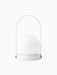A back view of the white Carrie Table Lamp. It features a glowing glass orb on a round base with a slim, arched handle.