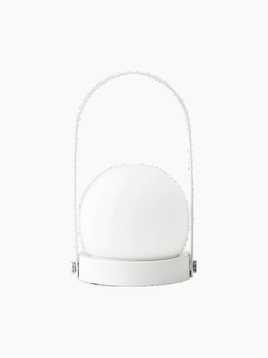 The Carrie Table Lamp, Portable, in white. It features a frosted glass orb on a round base with a thin handle.