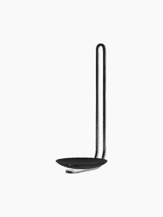 Angled view of the minimalist black Clip Candle Holder for walls, with a sleek, looped frame and a small dish for a candle.