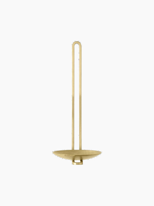 The brass Clip Wall Candle Holder viewed from the front, showcasing its tall, slender U-shaped handle and circular base.