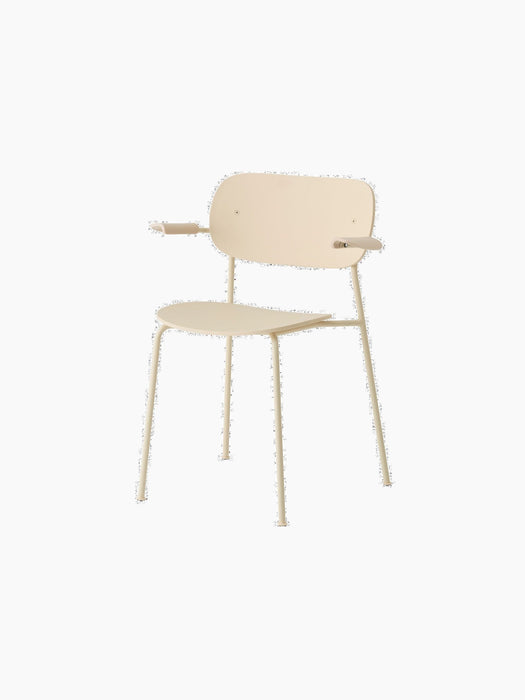 Angled view of the ivory Co Dining Chair, Outdoor, with armrests. The chair features a simple design with slim metal legs.