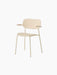 Angled view of the ivory Co Dining Chair, Outdoor, with armrests. The chair features a simple design with slim metal legs.