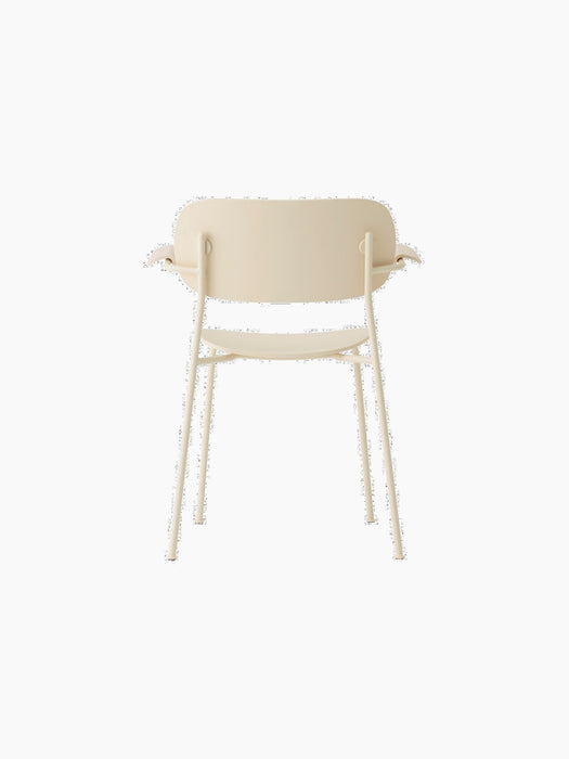 Rear view of the ivory Co Dining Chair, Outdoor. The chair has a slim frame, solid seat, and curved backrest with armrests.