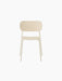 A front-facing view of the Co Dining Chair, Outdoor, in an ivory finish. The minimalist chair has no armrests.